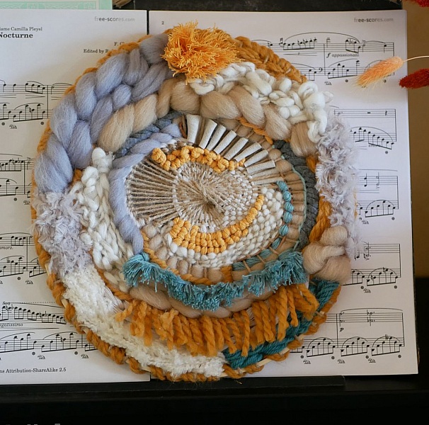 Tissage rond mural contemporain et boh&egrave;me aux pompons fantaisie