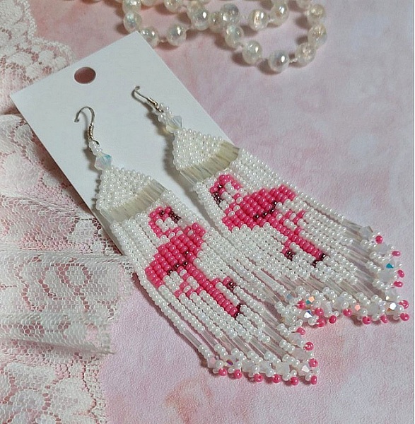 BO Les Flamants Blancs et Roses mont&eacute;es aux rocailles de qualit&eacute; en verre. Couleurs : Blanc et Rose. S&rsquo;ajoute aux rocailles des toupies Blanches. Le tout est associ&eacute; &agrave; des crochets en argent 925.