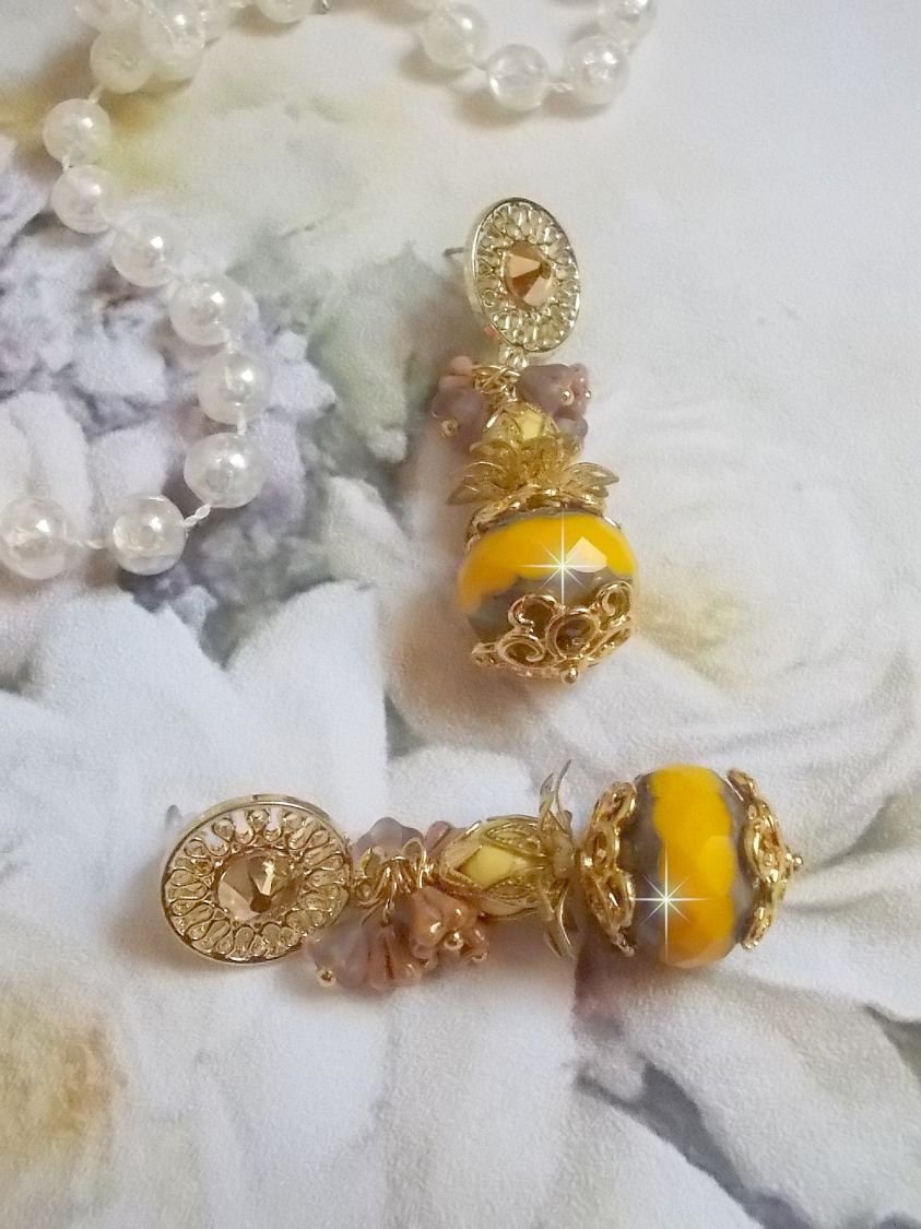 BO Lumière Opale Jaune avec des perles potirons jaunes à laquelle s’ajoute des fleurs, cabochons en cristal, coupelles et perles rondes. Montés sur clous d’oreilles en Métal. Un style moderne