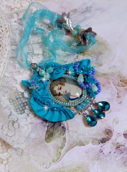 Pendentif Mademoiselle au style r&eacute;tro avec cabochon d&rsquo;une femme souriante, orn&eacute; d&rsquo;un ruban de soie Bleu, cristaux, perles verre : rocailles et roses, coupelles et cha&icirc;ne Argent 925/1000